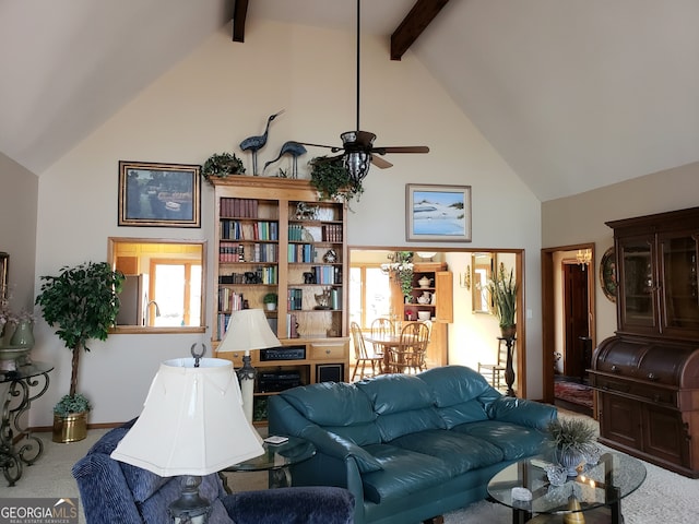 carpeted living room with ceiling fan, high vaulted ceiling, and beam ceiling