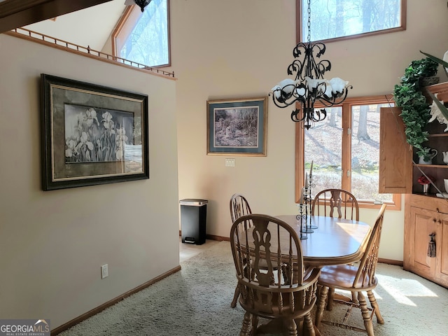 carpeted dining room with an inviting chandelier and a high ceiling