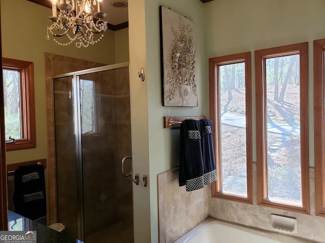 bathroom featuring a notable chandelier, plenty of natural light, shower with separate bathtub, and ornamental molding