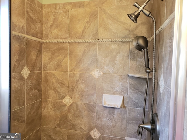 interior details featuring a tile shower