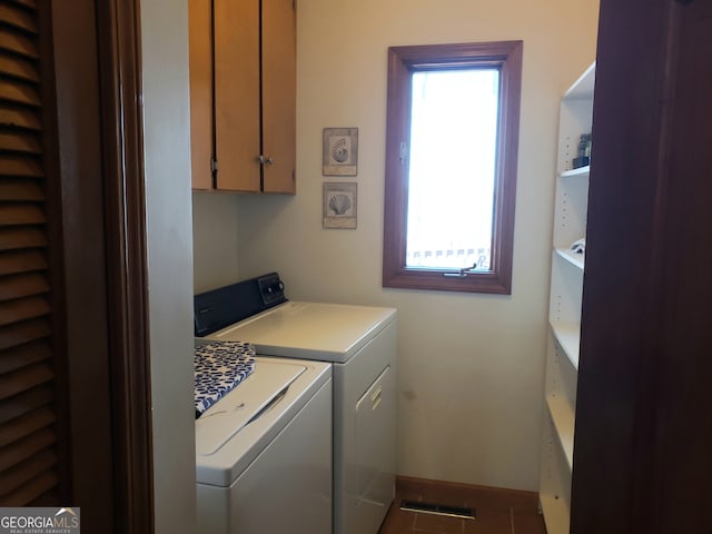 washroom featuring cabinets and washer and dryer