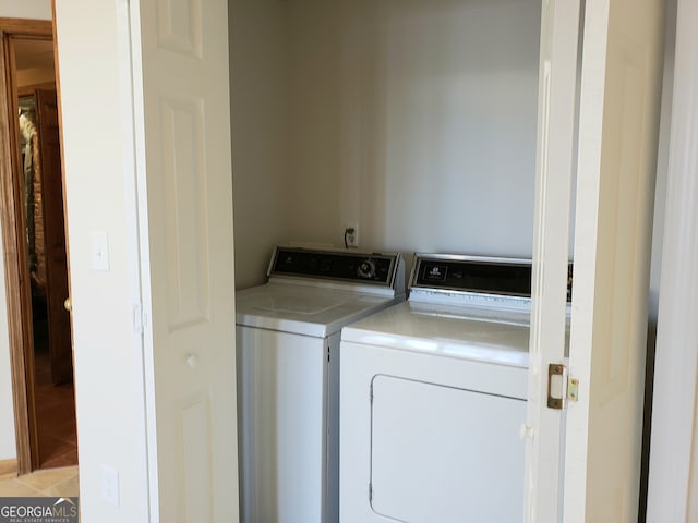 laundry room with light tile flooring and washer and dryer