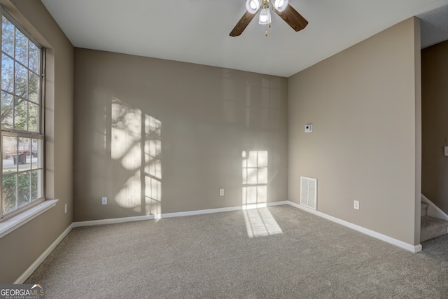 carpeted empty room featuring ceiling fan