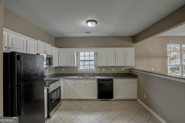 kitchen with white cabinets, sink, light tile floors, and black appliances