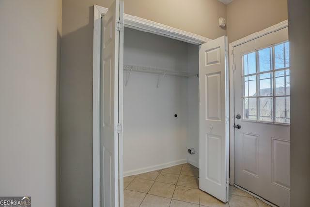 washroom featuring light tile floors and hookup for an electric dryer