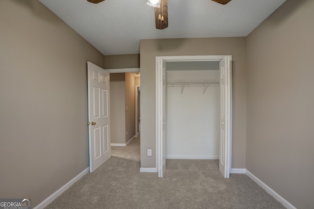 unfurnished bedroom with a closet, ceiling fan, and light colored carpet