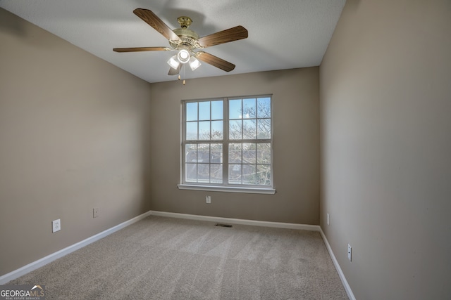 empty room featuring light carpet and ceiling fan