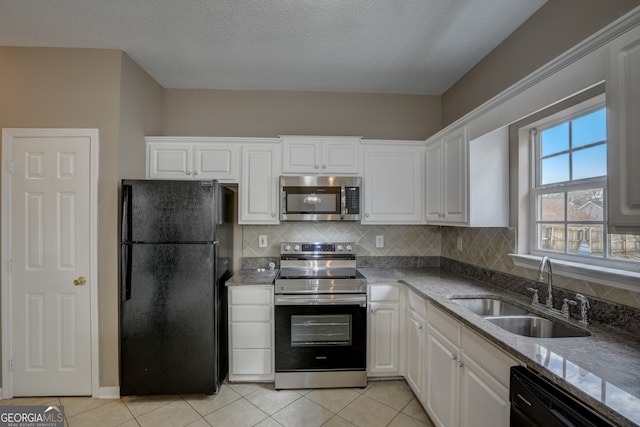 kitchen featuring light tile floors, stone countertops, black appliances, white cabinetry, and sink