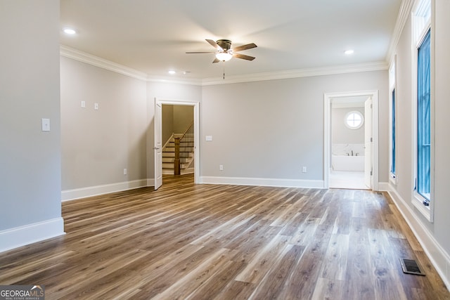 unfurnished room featuring ceiling fan, ornamental molding, dark hardwood / wood-style floors, and plenty of natural light