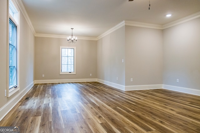 spare room with crown molding, ceiling fan with notable chandelier, and dark hardwood / wood-style floors