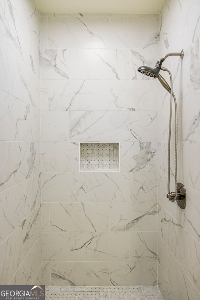 bathroom with tiled shower