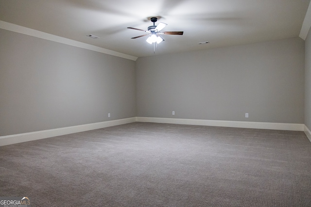 unfurnished room featuring crown molding, ceiling fan, and dark carpet