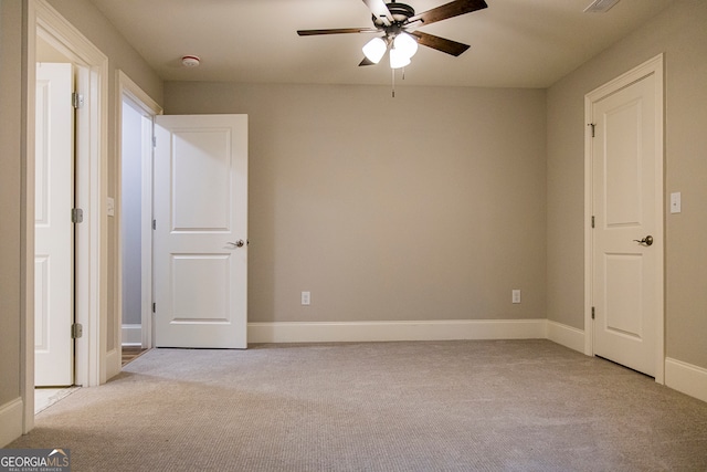 interior space featuring ceiling fan and light colored carpet