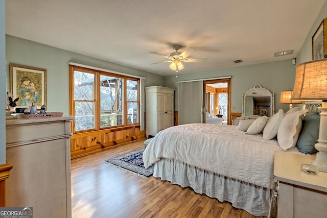 bedroom with light hardwood / wood-style floors and ceiling fan