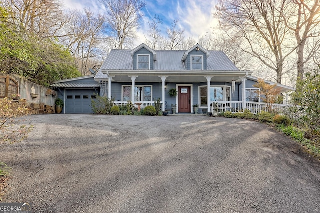 view of front facade with covered porch and a garage