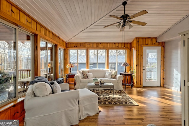 sunroom featuring lofted ceiling, ceiling fan, and wood ceiling