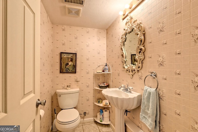 bathroom with tile patterned flooring and toilet