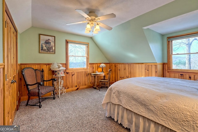 carpeted bedroom featuring a closet, vaulted ceiling, multiple windows, and ceiling fan