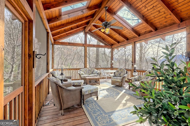 sunroom / solarium with ceiling fan, lofted ceiling with skylight, and a wealth of natural light