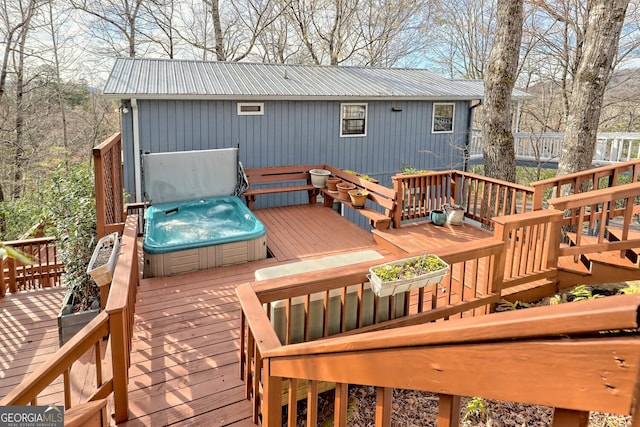 wooden terrace featuring a covered hot tub