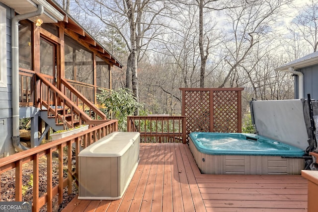 wooden deck featuring a covered hot tub