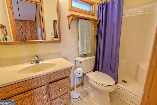 bathroom featuring tile patterned flooring, a shower with shower curtain, vanity, and toilet