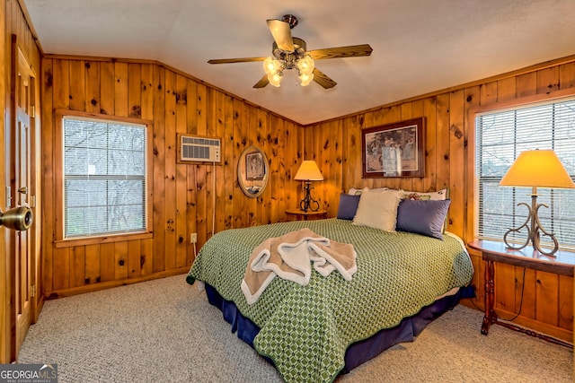 bedroom with ceiling fan, wood walls, vaulted ceiling, and a wall mounted AC