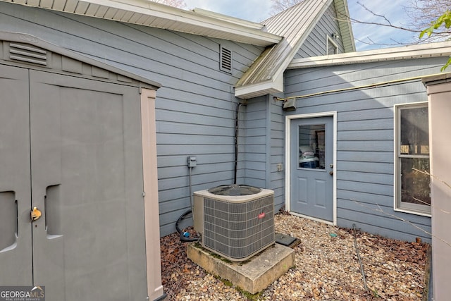 details featuring central AC and wooden walls