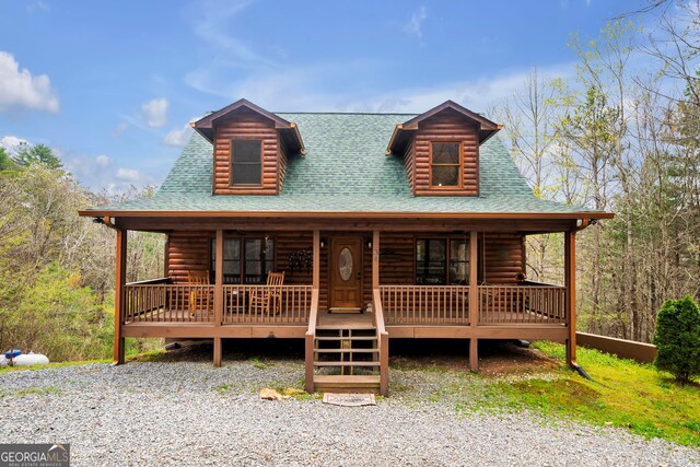 log home featuring covered porch