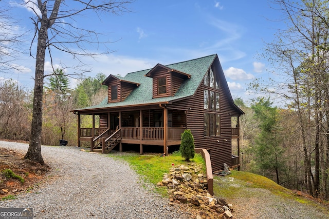 log-style house with a porch