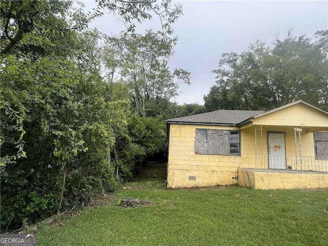 view of side of home with a lawn