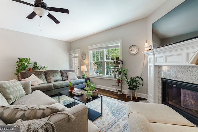 living room featuring ceiling fan and hardwood / wood-style flooring