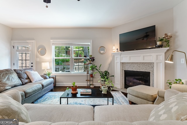 living room with ceiling fan and light wood-type flooring