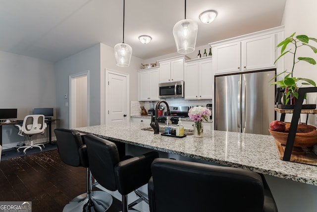 kitchen featuring white cabinetry, backsplash, dark wood-type flooring, and stainless steel appliances