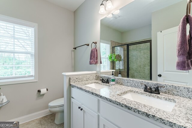 bathroom with oversized vanity, toilet, dual sinks, and tile flooring