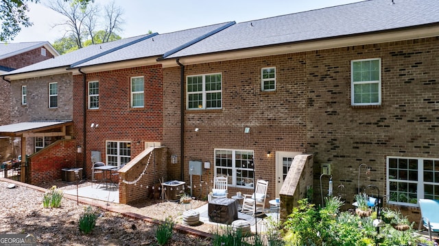 rear view of house with a patio and central AC