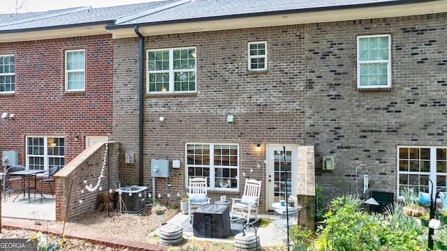 back of house with central air condition unit and a patio area