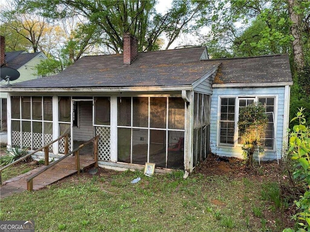 view of front of house with a sunroom