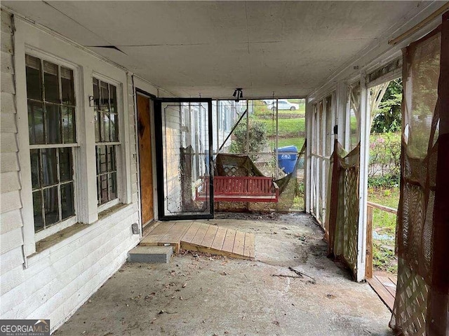 unfurnished sunroom featuring plenty of natural light