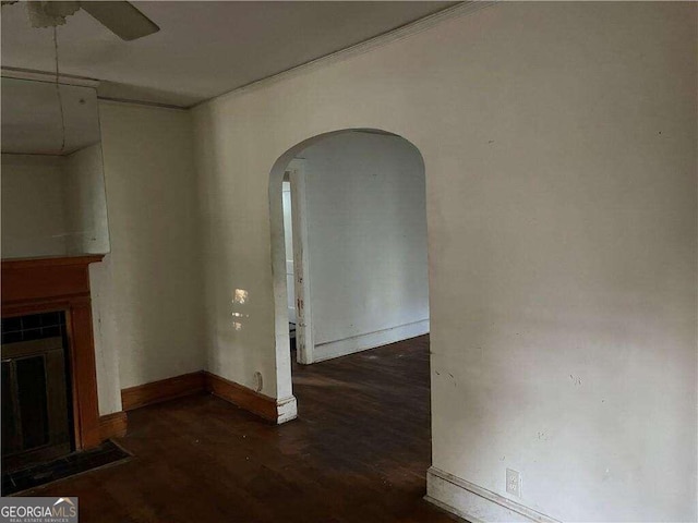 unfurnished living room with ceiling fan and dark hardwood / wood-style flooring