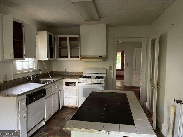 kitchen featuring plenty of natural light, white appliances, white cabinetry, and sink