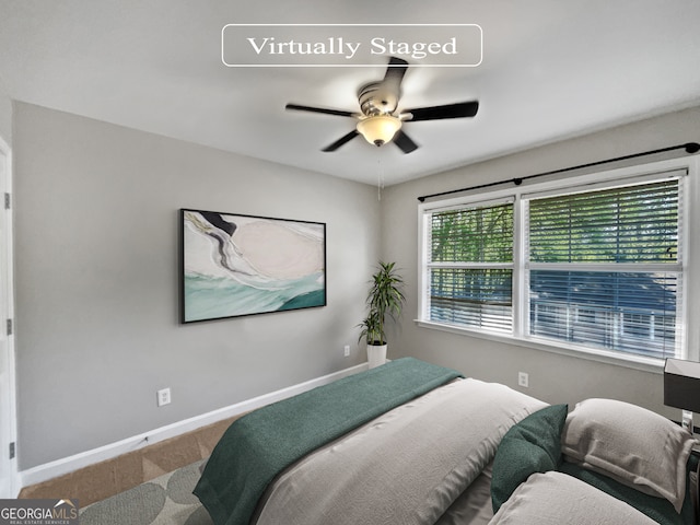 bedroom featuring ceiling fan and carpet