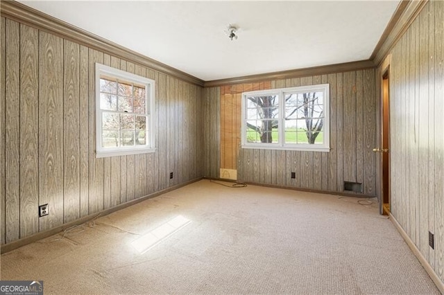 unfurnished room with light colored carpet and ornamental molding