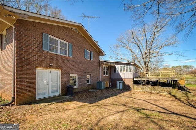 rear view of property featuring cooling unit and french doors