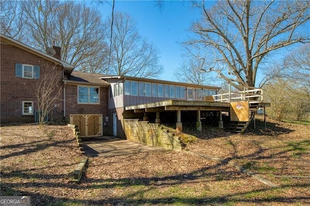 back of property featuring a wooden deck