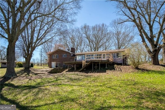 back of house with a yard and a deck