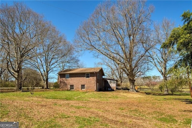 view of side of home featuring a yard