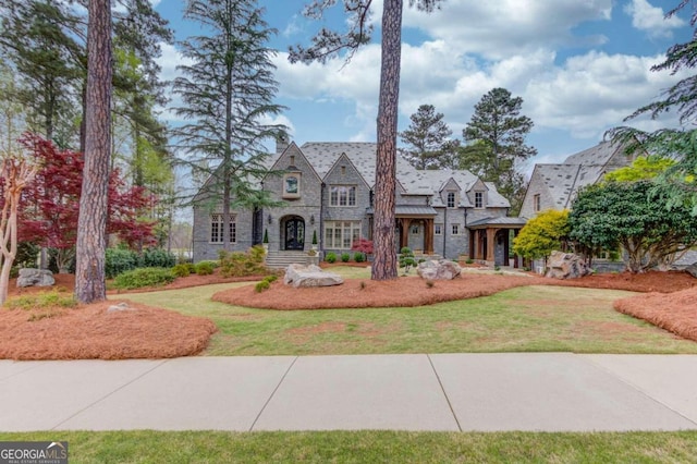 tudor house featuring a front yard