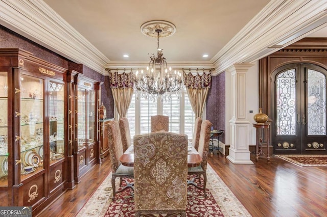 dining space with decorative columns, dark hardwood / wood-style floors, a chandelier, and french doors