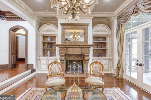 living area featuring an inviting chandelier, dark wood-type flooring, and a wealth of natural light